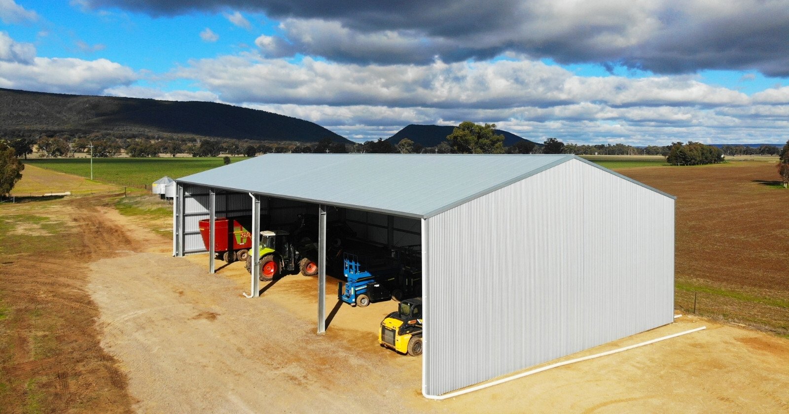 Professional-grade farm shed kit protecting valuable machinery and equipment from weather damage