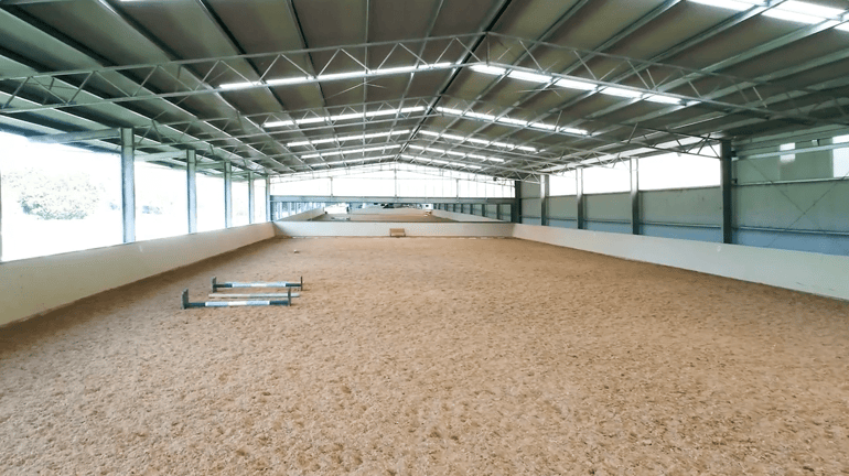 Partially enclosed dressage arena