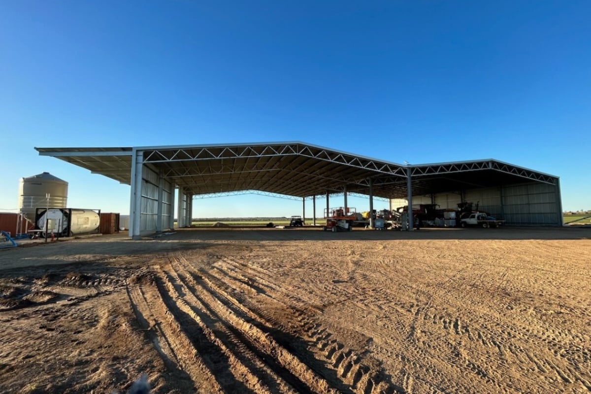 Farm machinery shed with awnings
